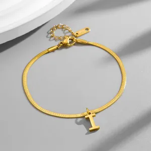 Close-up detail view of elegant gold snake chain bracelet featuring initial letter pendant.