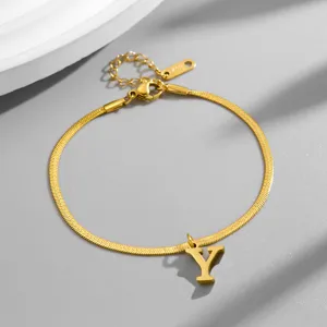 Close-up detail shot of gold stainless steel snake chain bracelet featuring letter Y pendant.