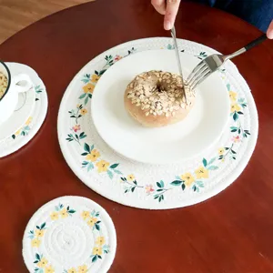 Round braided heat resistant table placemat with floral print for dining table decoration use.