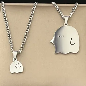 Detail view of the cute little ghost couple necklace, featuring polished silver finish pendants.