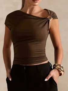 Closeup view of women asymmetric off shoulder brown crop top with elegant gold buckle detail.