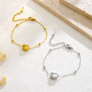 Minimalist stainless steel heart anklet set in gold and silver, perfect for summer beach wear.