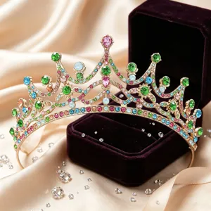 Detailed shot of a gorgeous gold alloy tiara encrusted with vibrant colorful rhinestones.