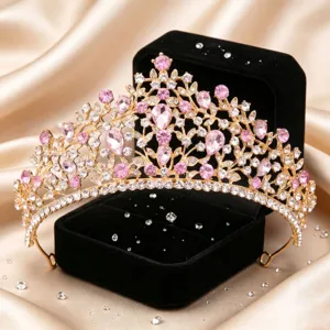 Gold bridal tiara crown with pink and clear rhinestones for wedding hair accessory detail display.