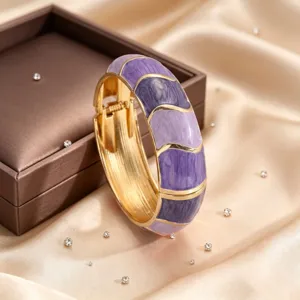 Detailed shot of purple enamel bangle, unique wave color-blocking design, premium jewelry.