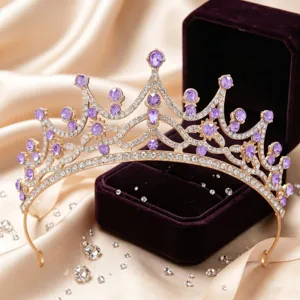 Closeup detail of stunning gold rhinestone tiara with purple gems for wedding party hair accessory.