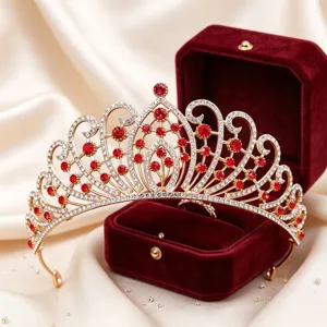 Exquisite gold tiara with red rhinestones, detailed craftsmanship for bridal wedding hair styling.