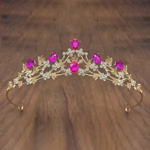 Children's golden crystal tiara with pink teardrop rhinestones, detail closeup shot.