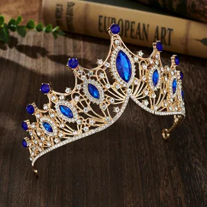 Stunning baroque gold tiara detailed with sparkling blue and clear rhinestones for bridal events.