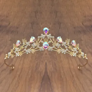 Close-up detail of a gold children princess crystal tiara with sparkling rhinestones and gems.