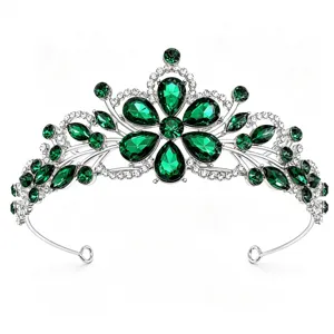 Close-up of gorgeous silver bridal tiara featuring sparkling deep green rhinestone crystals.