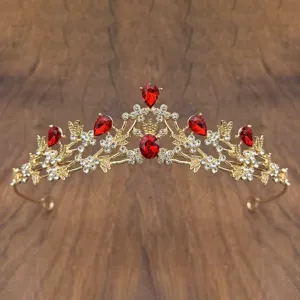 Gold princess crown kids tiara detail showing intricate metalwork and sparkling red rhinestones.