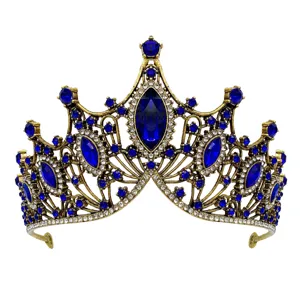 Close-up detail of vintage baroque gold crown with deep blue gemstones and clear rhinestones.