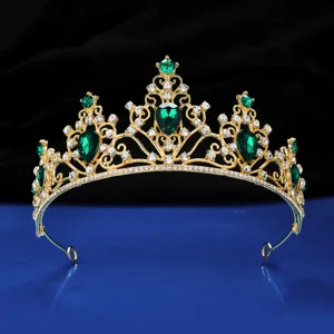 Gold bridal tiara crown with emerald green teardrop gems and rhinestones for wedding party.