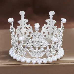 Detailed view of miniature alloy pearl crown tiara for cake decoration and floral design.