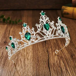 Close-up detail of silver crystal tiara with green teardrop rhinestones for bridal wedding.