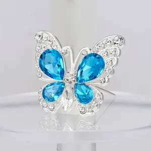 Broche de mariposa de cristal, accesorio floral decorativo de aleación con diamantes azules.