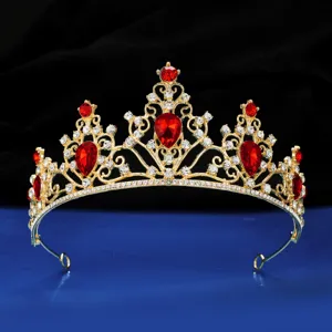 Gold bridal tiara hair accessory with red crystal and rhinestones for wedding party detail view