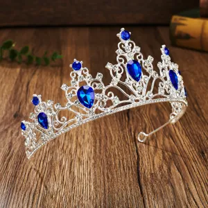 Stunning silver bridal tiara with blue teardrop rhinestones, perfect wedding hair accessory for parties.