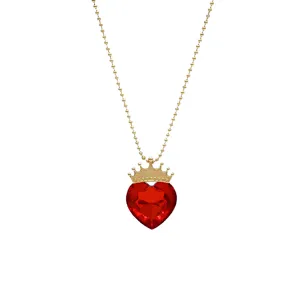 Detail view of the gold bead chain necklace with red heart crown crystal pendant.