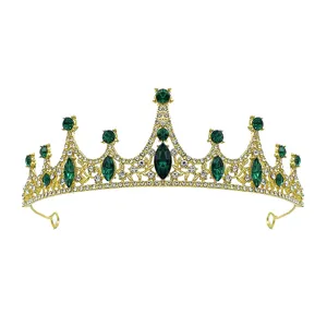 Gold crystal tiara crown detail close-up, sparkling green and clear rhinestones for girls hair.