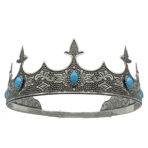 Detailed view of antique silver crown with blue stones, vintage royal tiara for party costume.