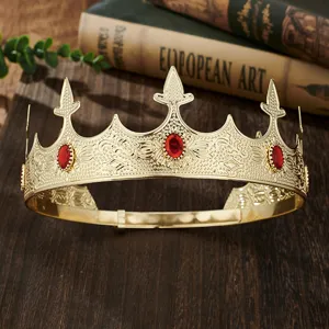 Detail shot of a golden king crown with red gems, perfect for parties and events.