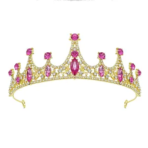 Close-up detail of golden princess tiara featuring sparkling pink and clear crystals.