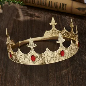 Detailed view of golden crown with red rhinestones, vintage royal design for party costume.