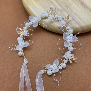 Exquisite floral hair vine with pearls and translucent petals, perfect for girls and brides.