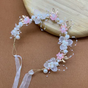 Kids floral hairband with pearls and pink flowers, perfect for birthdays and parties.