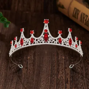 Detailed view of children princess crown tiara with sparkling red rhinestones and silver band.