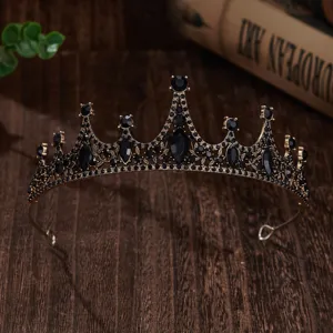 Close-up of vintage black crystal tiara, antique gold finish crown detail for special event.