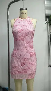 Full length detail of a pink halter dress with floral sequin patterns and beads