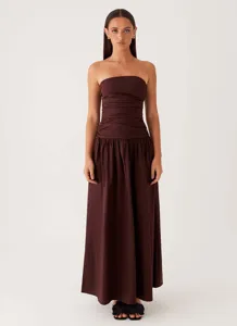 Full view of elegant brown strapless maxi dress with ruched bodice on a fashion model.
