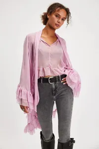 Detail of lavender sheer ruffled blouse with flared lantern sleeves and bohemian style.