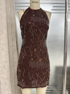 Detailed view of dark brown halter dress with intricate sequin and bead floral embroidery.