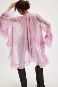 Back view detail of a sheer lavender ruffled chiffon blouse with voluminous flared sleeves.