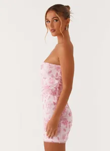Side view detail of a pink strapless bodycon mini dress with floral sequin embroidery.