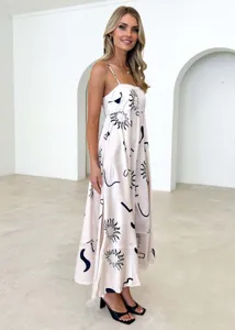 Detailed side view of summer maxi dress featuring abstract sun and moon print with thin straps