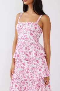 Detailed view of pink and white floral tiered dress with delicate camisole straps
