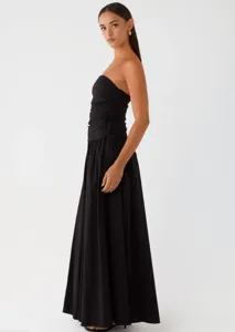 Close-up view of the black strapless shirred bodice on the elegant maxi dress, fine texture.