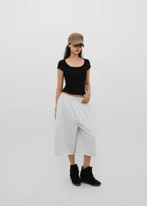 Full body view of a woman wearing American retro gray loose drawstring cropped sweatpants