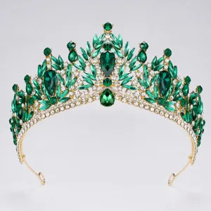 Detailed view of luxury baroque green crystal tiara, exquisite gold-tone bridal crown.