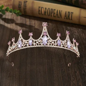 Detailed view of a gorgeous rose gold tiara with purple and clear rhinestones for girls.