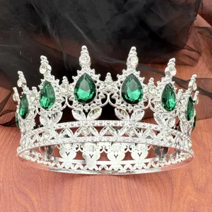 Dettaglio in primo piano di una splendida corona barocca argentata con cristalli verdi e strass.
