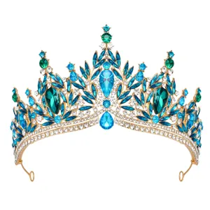 Close-up detail of a stunning gold tiara with sparkling blue and green crystal rhinestones.
