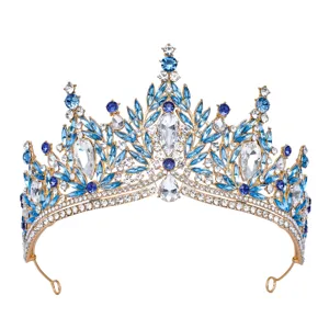 Exquisite crystal tiara detail, featuring blue and clear rhinestones on a gold-plated base.