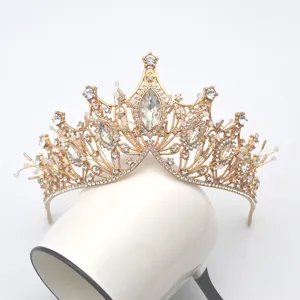 Vue rapprochée de la tiare couronne dorée vintage avec cristaux marquise et strass scintillants.