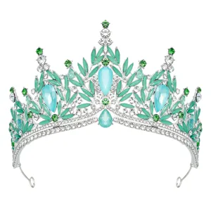 Detailed close-up of a silver crystal bridal tiara with mint green stones and rhinestones.